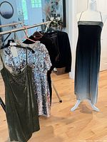All five garments on rack and mannequin