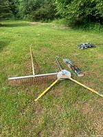 Wide view showing Weed Raker, Weed Razer, ropes and box on lawn
