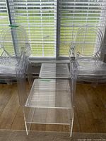 stacked clear acrylic chairs and side tables
