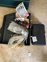 Open toolbox showing rotary tool, accessory sets and assorted bits