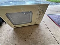 Front view of cream Danby microwave showing window and two rotary dials