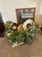 Group shot showing artwork, wreaths, hats, faux plants