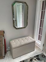 Mirror and ottoman together for scale and context