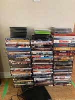 Three tall stacks of DVD cases plus jewel cases