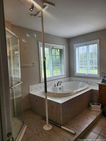 Full view of installed grab pole beside bathtub