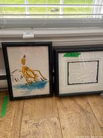 Both framed artworks side by side for scale and comparison