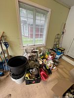 Wide view of lot with soil bags, tools, planters, chemicals, shovels