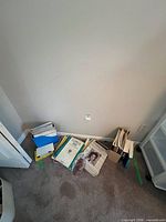 Stacks of sheet music, books and kalimba on floor