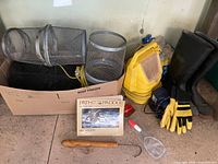 Group shot of traps, boots, book, float, yellow case, carrier blocks, gloves