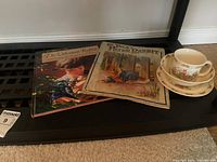 Lot overview showing two books and stacked Bunnykins dish set