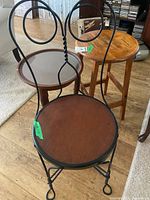 Group shot of round glass-top table, wooden stool, and metal chair