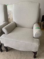 Front view of armchair showing upholstery, seat cushion, legs