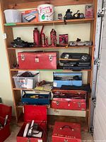 Front view of full-height wooden shelving unit with tools on shelves (contents not included)