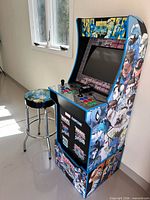 Front left view of arcade cabinet with stool