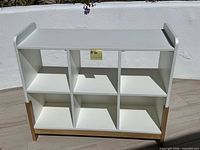 Front view of white bookshelf showing six compartments