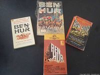 All four items laid out: three paperback books and sealed VHS