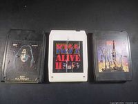 Front view of three KISS 8-track cartridges showing album art