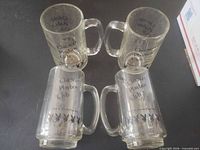 All four Chicago Playboy Club glass beer steins upright and inverted showing logos and handles