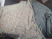 Vest and sweater together showing unfinished edges