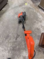 Full view of string trimmer/edger from handle to wheel base