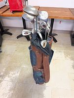 Golf bag with clubs standing upright