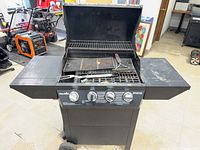 Front view of Char-Broil Advantage grill with lid open, side shelves extended