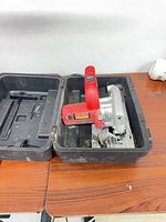 Circular saw seated in open case showing overall lot