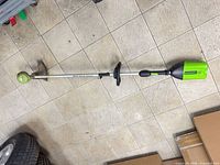 Full view of Greenworks Pro cordless string trimmer with battery attached