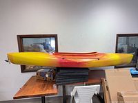 Full side view of Old Town kayak showing length and color gradient