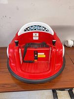 Front view showing seat, joysticks, battery compartment and belt