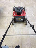 Top view of mower showing red deck, black Briggs & Stratton 550EX engine and handle assembly