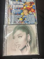 Front view of both sealed CDs showing cover art and shrinkwrap.