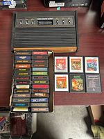 Console top view with cartridge slot and switches; box of stacked cartridges; six additional cartridges to right
