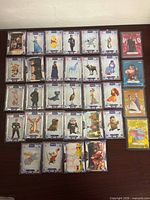 Grid view of 30 silver-border base cards with two stacks of foil cards on right, showing variety of Disney/Pixar characters