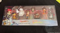 Front view of sealed Disney 100 Being By Your Side figure set showing all eight characters in packaging