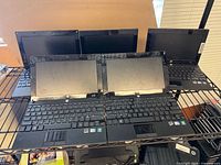 Five HP Mini netbooks open on shelf