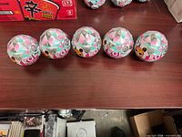 Five sealed LOL Surprise Fluffy Pets Winter Disco balls lined on table