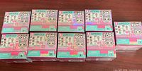 Nine unopened L.O.L. Surprise Tiny Toys Series 1 boxes displayed face up