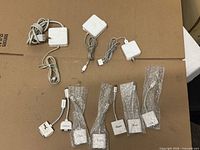 Overview of power adapters and video dongles on cardboard