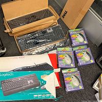Overview showing Dell keyboards, RolTek mouse boxes, Logitech and Microsoft boxed keyboards