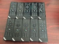 Front view of ten Vizio remotes in two rows showing control buttons