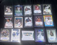 All 15 top-loaded autographed cards laid out
