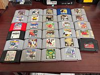 Front view of all 29 cartridges laid out in five rows on table