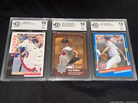 Front view of three BCCG graded cards in protective slabs