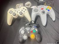 Group shot of three wired controllers displaying colors and designs