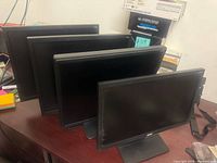 All four monitors grouped on desk