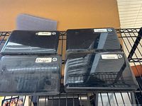 Top view of four closed HP netbooks showing lids and HP logos