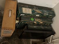 Stack of four Hanns.G monitor boxes beside one loose monitor