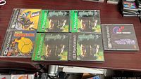 Seven PS1 games laid out on table showing front artwork