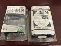 Front view showing both sealed Metra installation kits in packaging